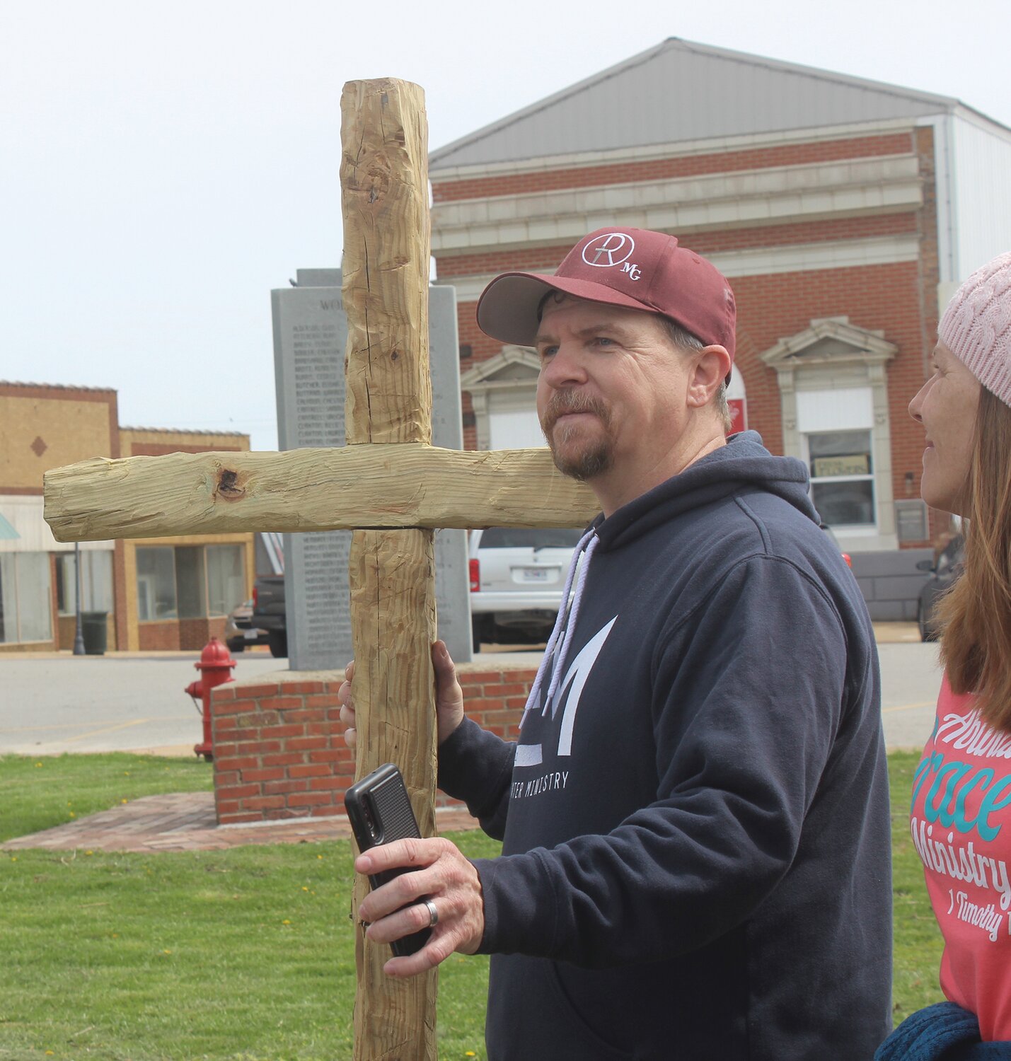 Pastor Ken Polm with a wooden cross carried from Cabool. He reflected on how the event started a few years ago with just five people carrying a cross.